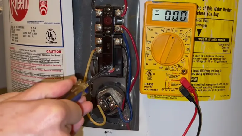 Plumber testing an electric water heater thermostat with a multimeter during water heater repair
